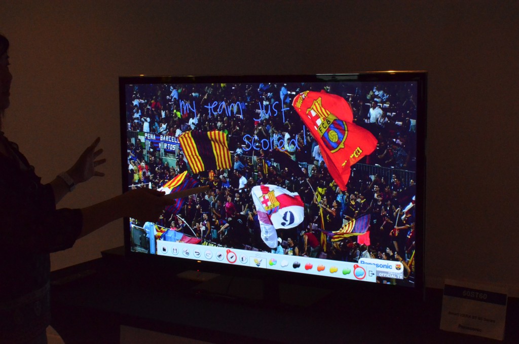 A company rep demonstrates a pen wand with the 50-inch model in Panasonic's ST60 plasma TV series. The photocell pen technology works only with the company's plasma -- not LCD --sets. (Photo: Ken Werner)
