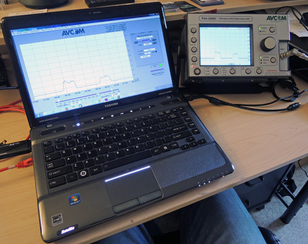 Part of my test rig, consisting of my trusty Toshiba laptop and an AVCOM PSA2500C spectrum analyzer.