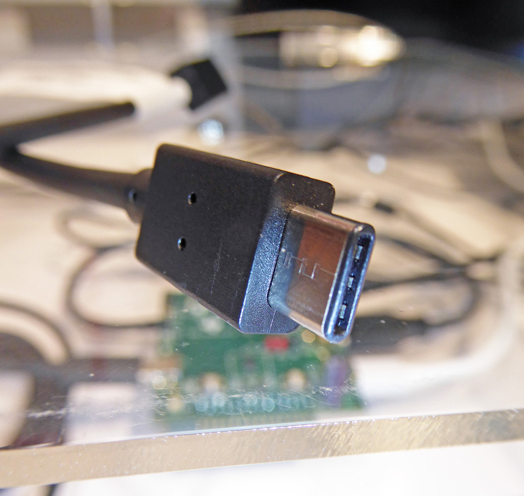 This little bugger is a brand-new USB 3.1 Type-C connector. Look for it to start appearing on mobile devices in 2015.